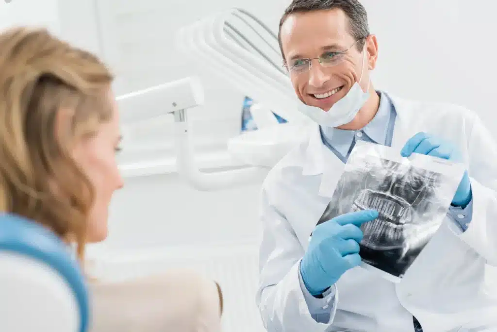 Dentist explaining dental X ray results before tooth extrctions in Riverview, MI.