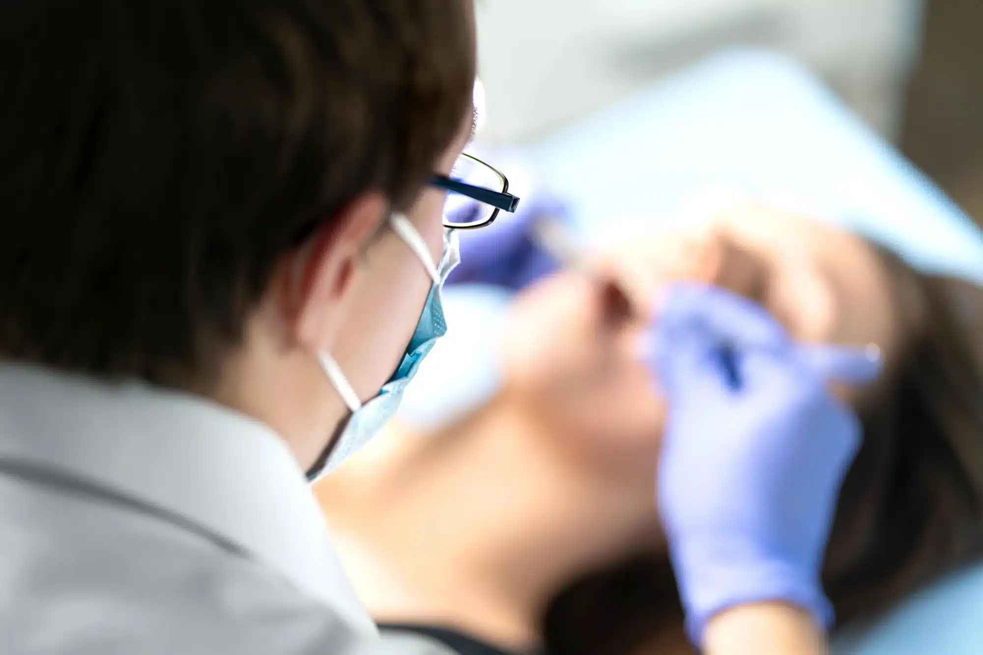 Dentist performing surgical wisdom teeth removal in Riverview, MI for impacted molars.