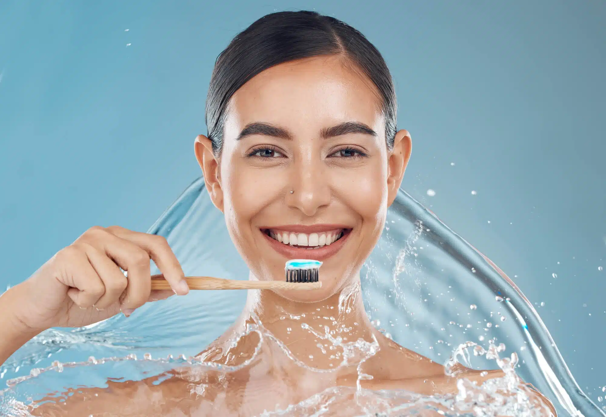 Happy girl holding a toothbrush wet in water from the dentist near Wyandotte, Mi